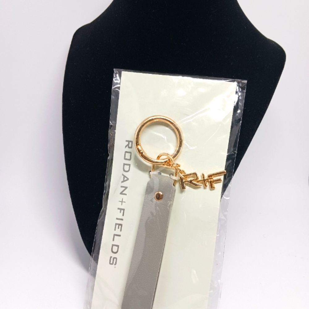 Rodan + Fields Gray and Gold Keychain